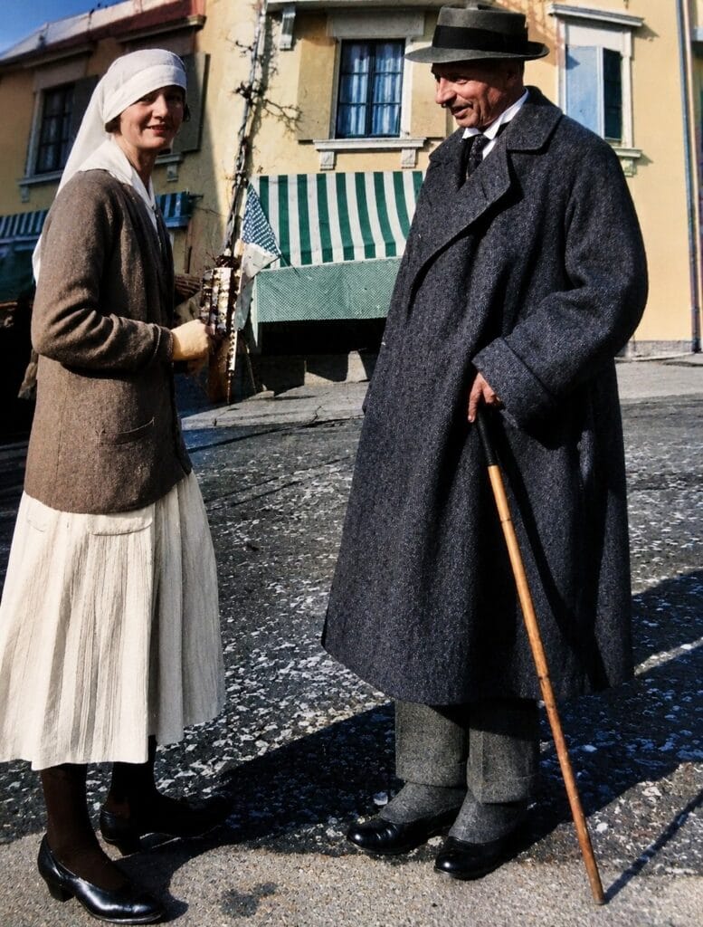 Rainer Maria Rilke in the final year of his life, standing with a cane beside a nurse outside the Val-Mont sanatorium in Switzerland.
