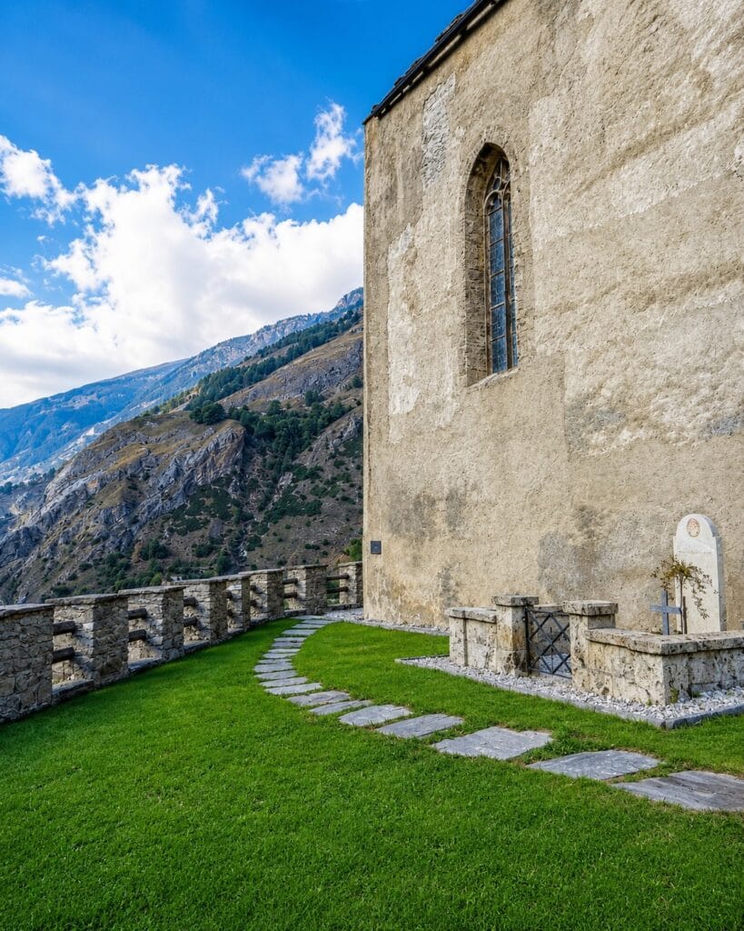 The grave of Rainer Maria Rilke beside the old Church of St. Romanus in Raron, overlooking the Rhône Valley in Switzerland.